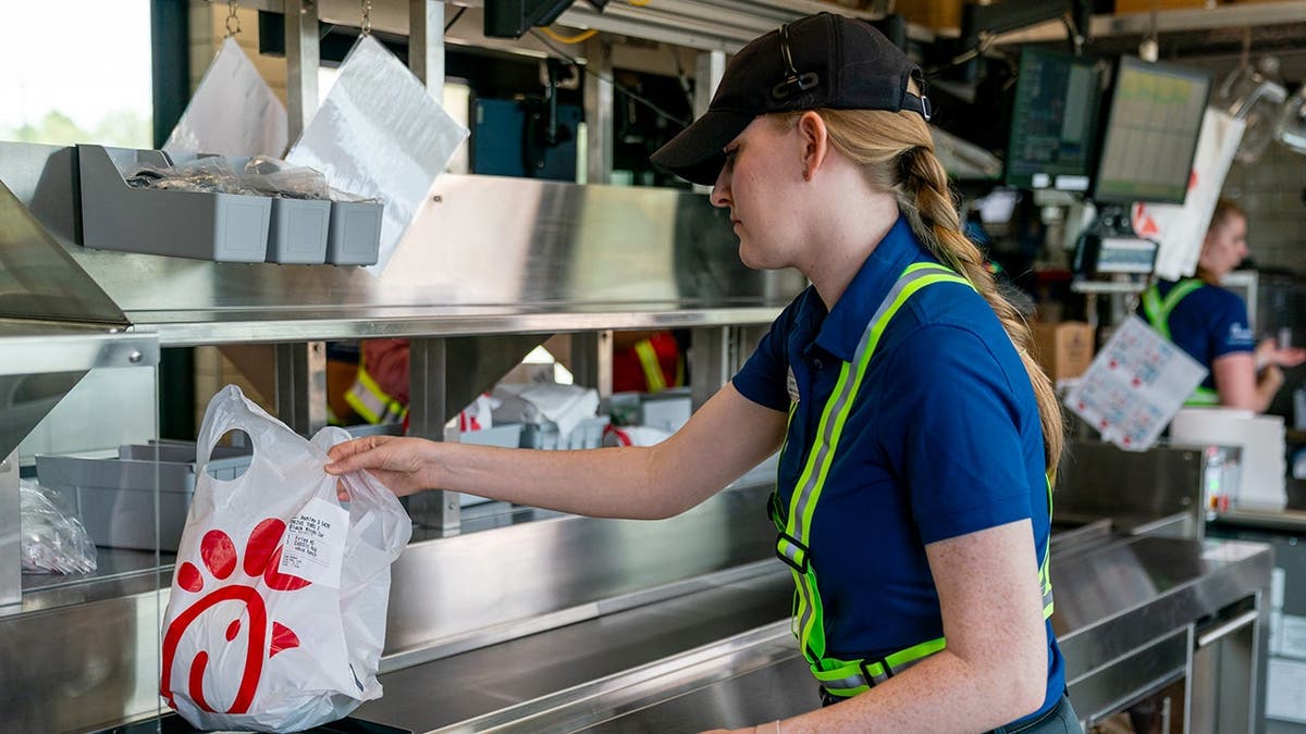 A Chick-fil-A employee prepares an order.