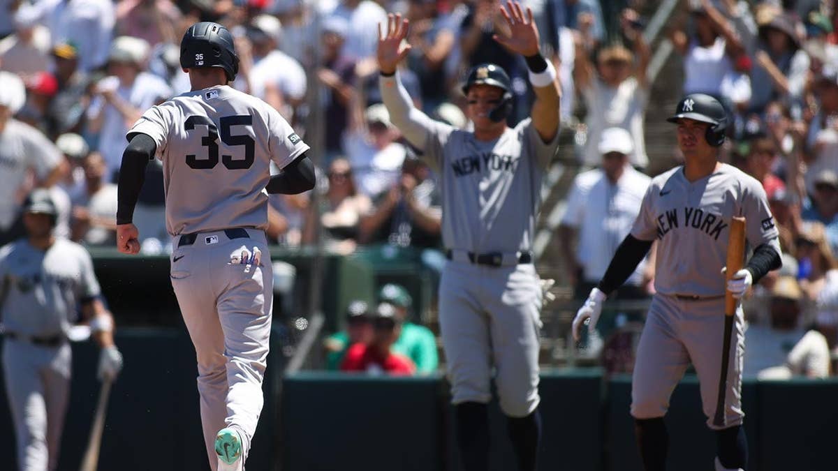 New York Yankees' Cody Bellinger running after scoring a run during a baseball game.