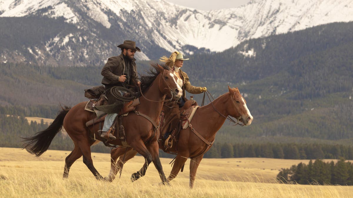 Cole Hauser as Rip Wheeler and Kelly Reilly as Beth Dutton standing in Dutton Ranch