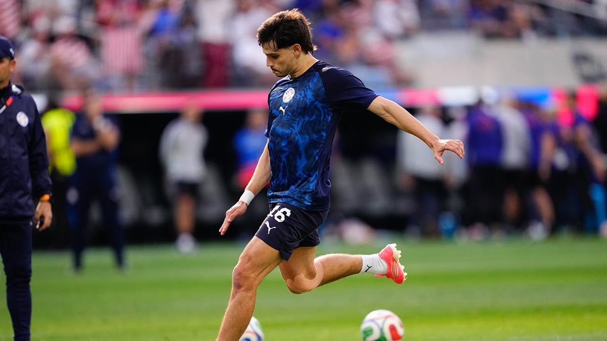 Damian Bobadilla warming up on the field at Los Angeles Stadium.