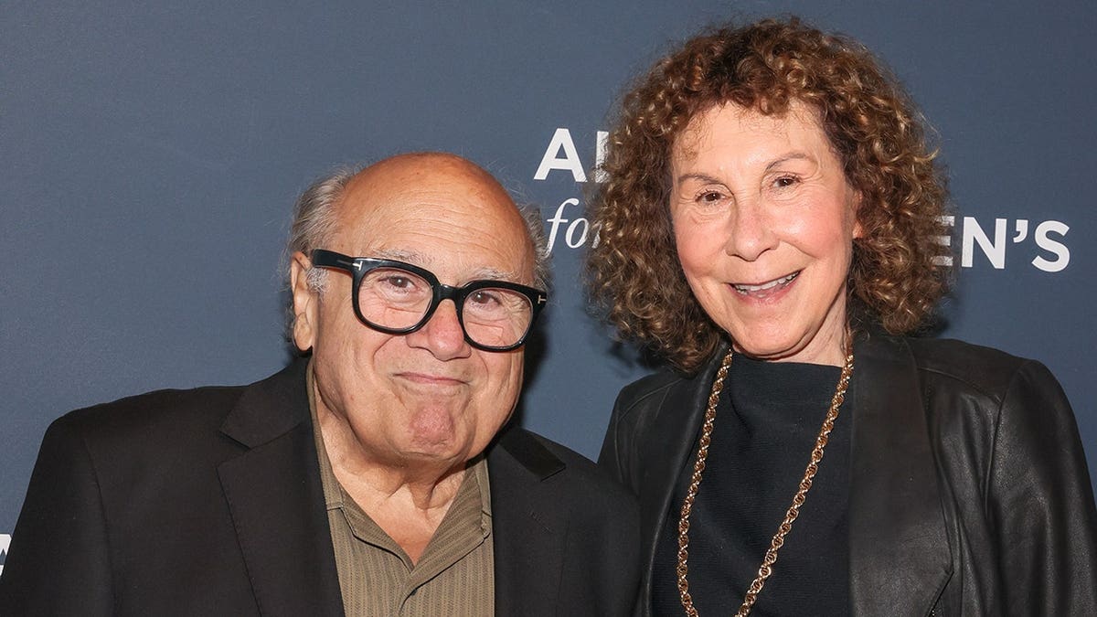 Danny Devito and Rhea Perlman standing together at a gala event