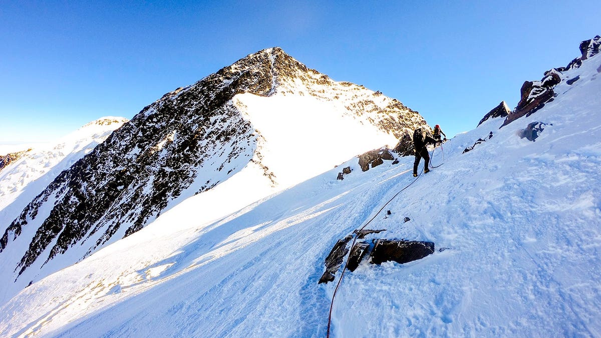 Male climber standing on a snowy slope in Denali National Park Alaska