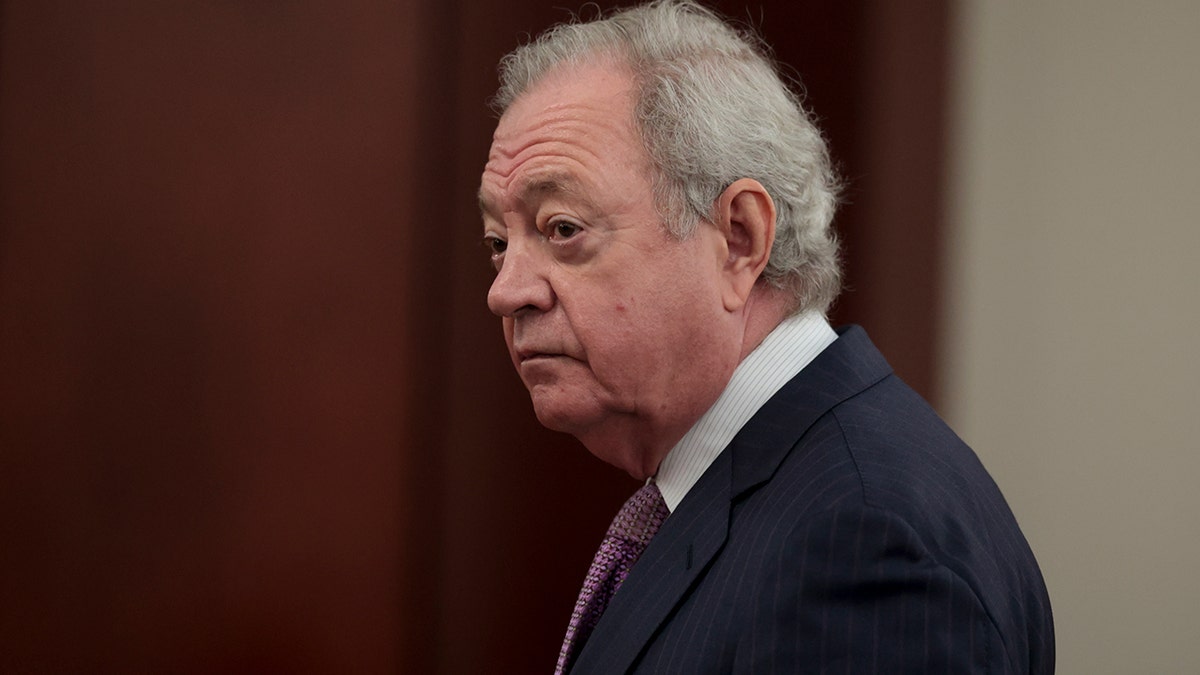 Defense attorney wearing a suit and tie.