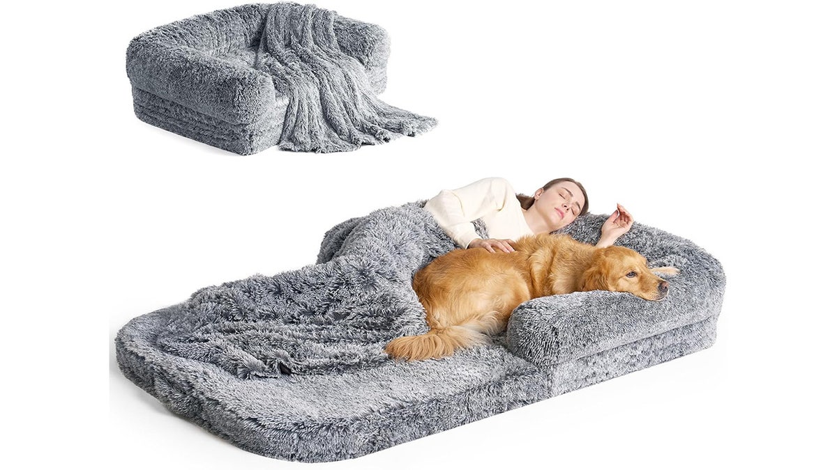 This human-sized dog bed comes with a matching throw blanket.