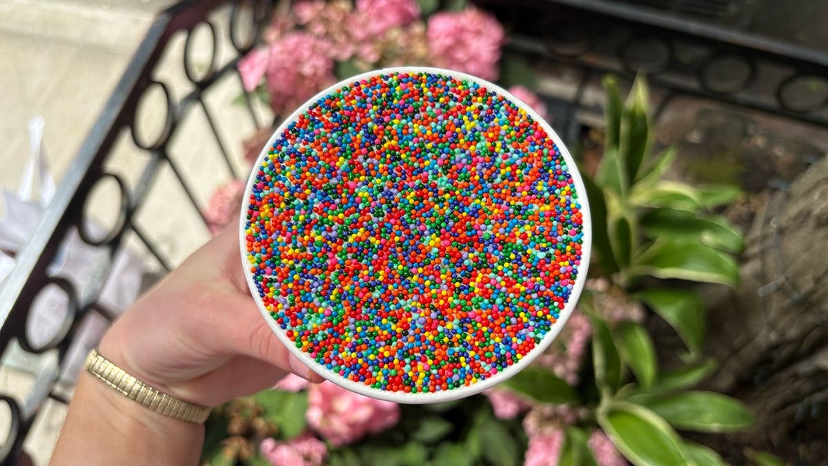 Individual cakes topped with a thick layer of rainbow nonpareil sprinkles