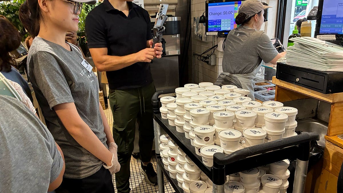 Staff at Butterfield prepare and organize dozens of Dot Cakes in individual containers behind the counter.