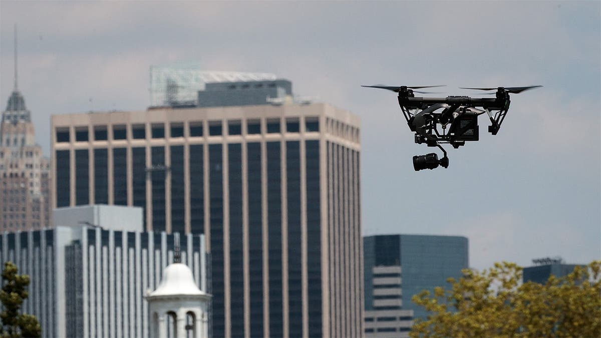 A drone hovers over buildings