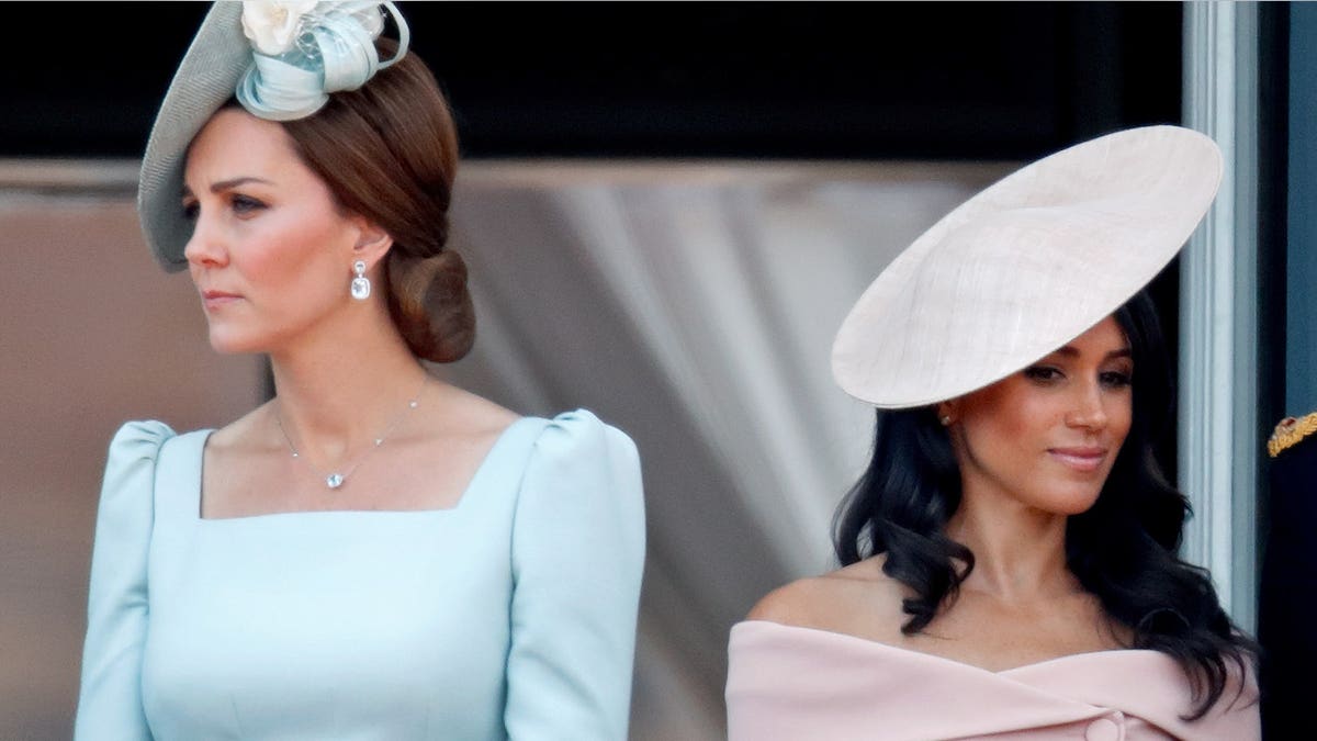 Catherine Duchess of Cambridge and Meghan Duchess of Sussex standing on Buckingham Palace balcony