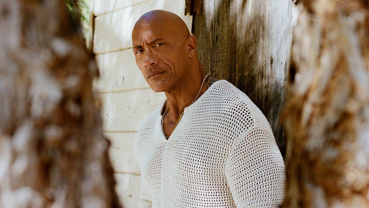 Dwayne Johnson poses in a white shirt