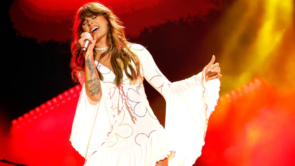 Ella Langley singing onstage at Nissan Stadium during CMA Fest in Nashville, Tennessee