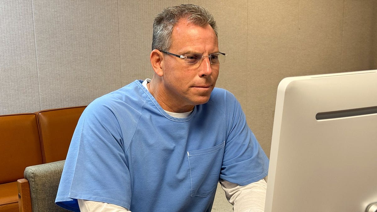 Erik Menendez appearing before parole board via teleconference at correctional facility