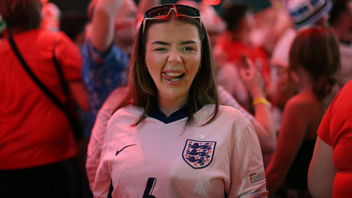 Fans celebrating victory at BOXPARK Wembley in London after FIFA World Cup match.
