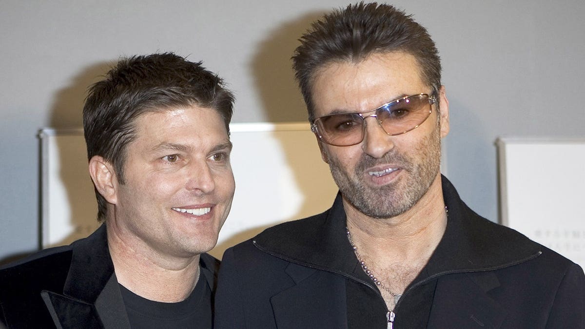 George Michael and partner Kenny Goss standing together at a Tokyo premiere event.