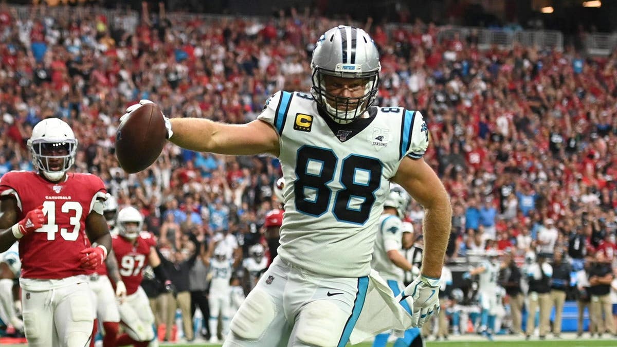 Carolina Panthers Greg Olsen scoring a touchdown astatine University of Phoenix Stadium.