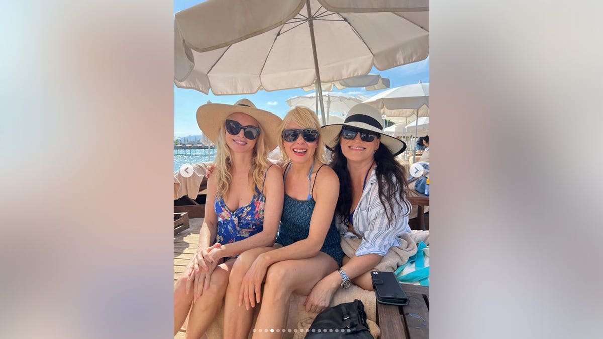 Heather Graham and her friends at a restaurant smiling together while in France.