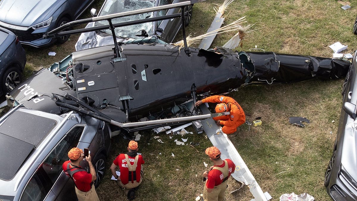 Firefighters working at helicopter crash site in Recreio dos Bandeirantes neighborhood Rio de Janeiro