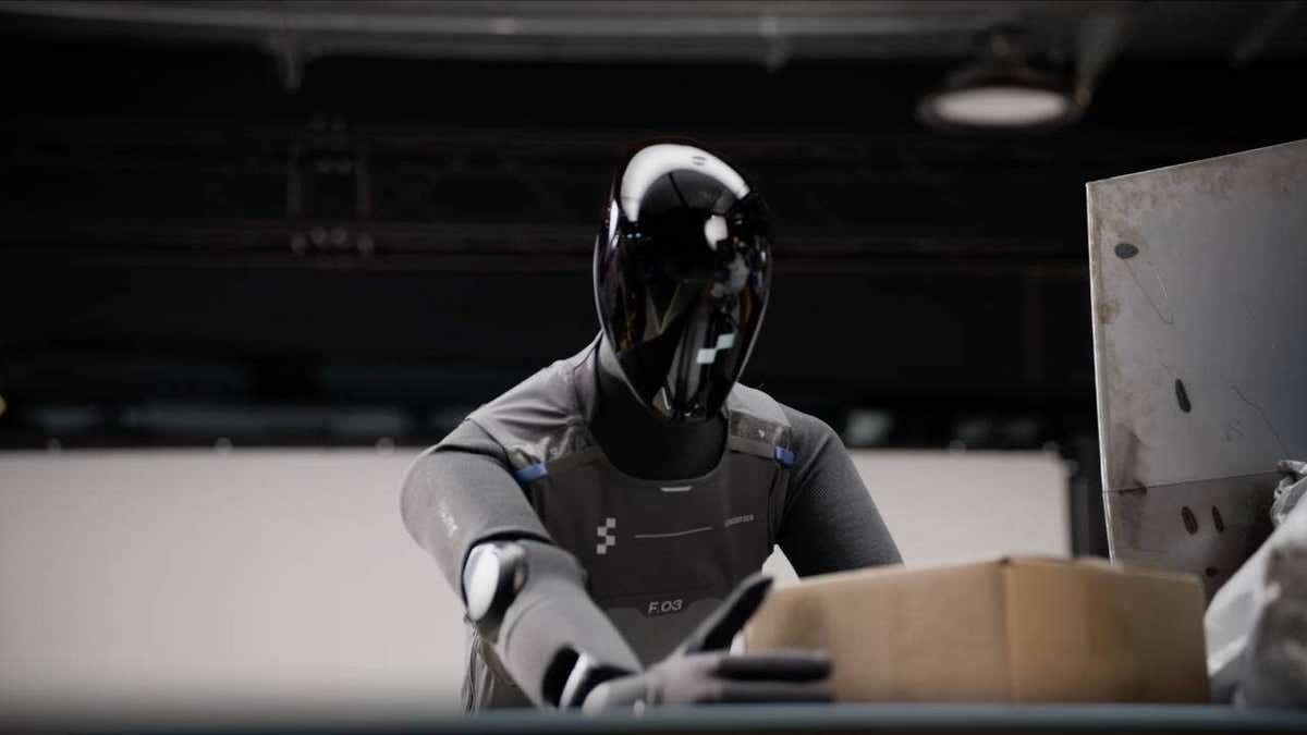 A humanoid robot handling a box