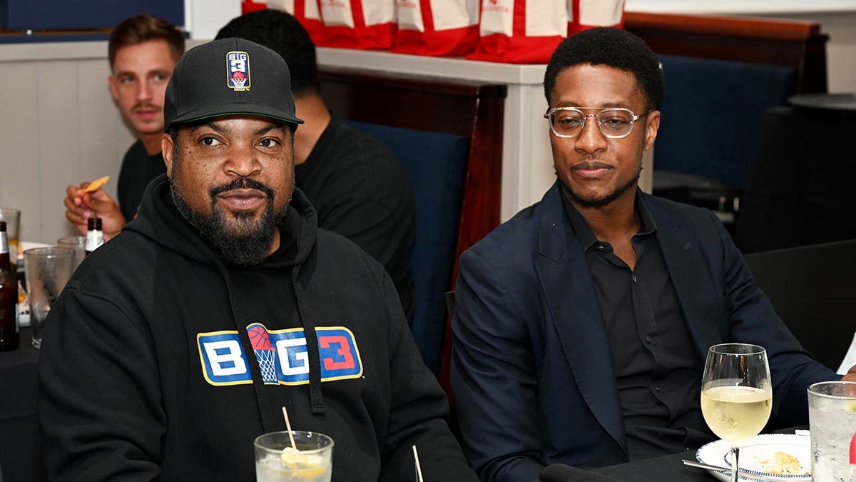 Ice Cube sits at a table with Damola Adamolekun.