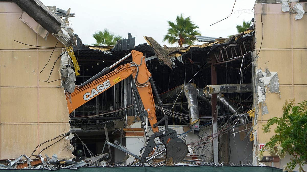 Demolition machinery tearing down former Macy's store at Indian River Mall