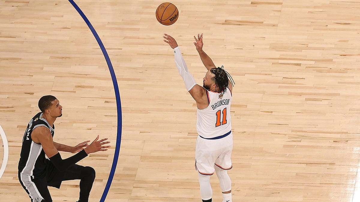 Jalen Brunson shooting a three-point handbasket  implicit    Victor Wembanyama astatine  Madison Square Garden