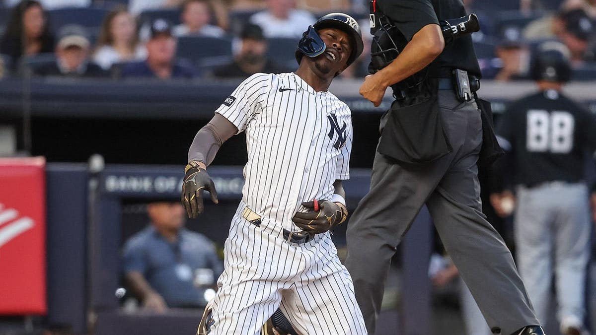 New York Yankees second baseman Jazz Chisholm Jr. reacts after hitting himself with a foul ball at Yankee Stadium.