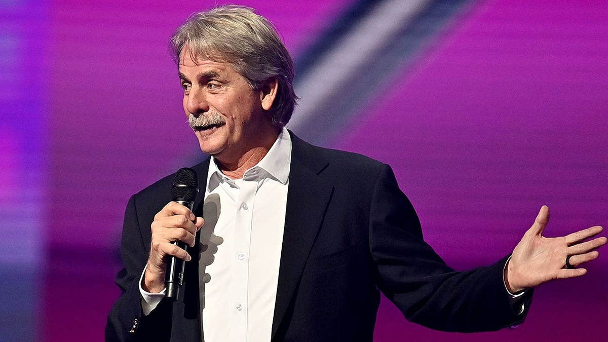 Comedian Jeff Foxworthy holding microphone onstage at Woodruff Arts Center