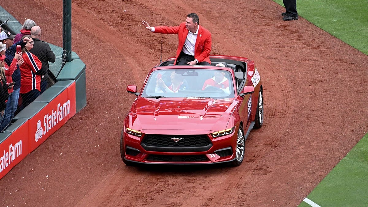St. Louis Cardinals hall of fame member Jim Edmonds rounding the warning track at Busch Stadium.