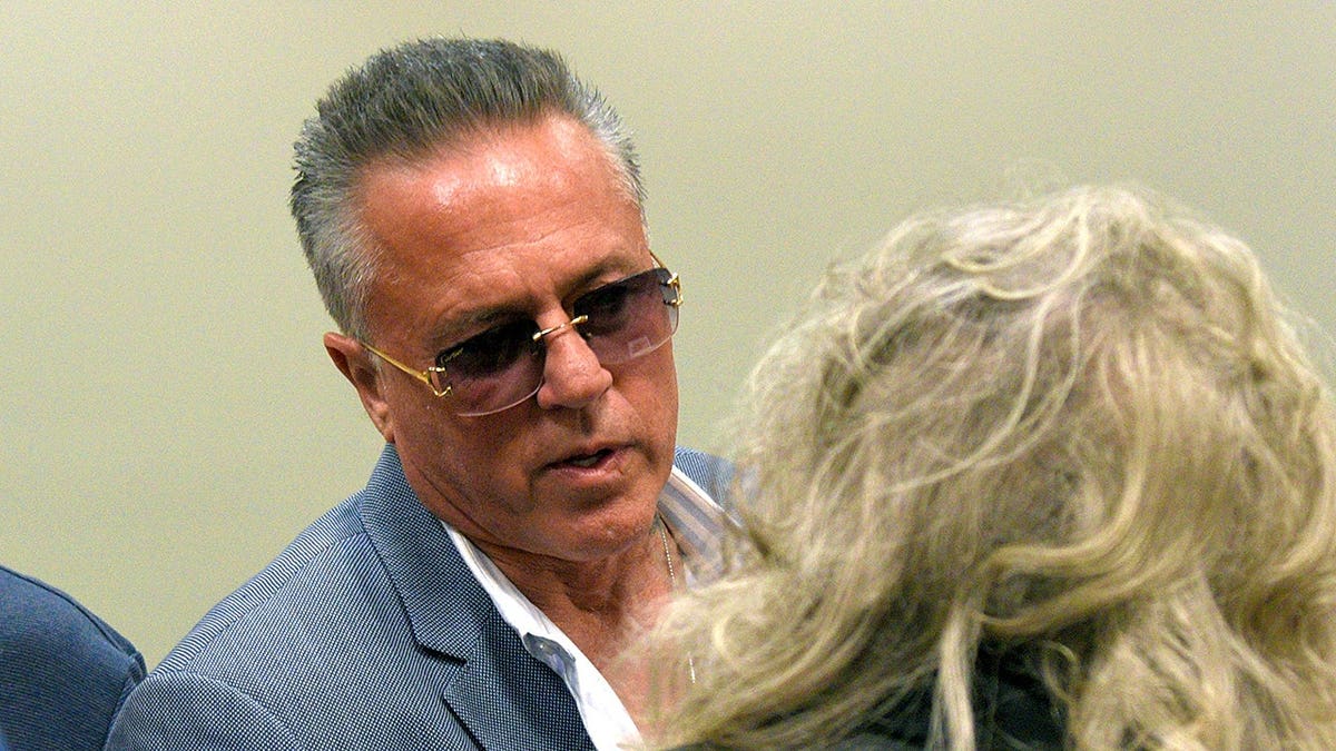 Englishtown Councilman John Alite speaking to a resident outside a municipal building.