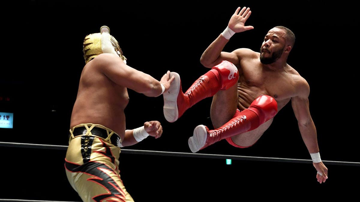 Jonathan Gresham and Tiger Mask wrestling in a ring at Korakuen Hall in Tokyo