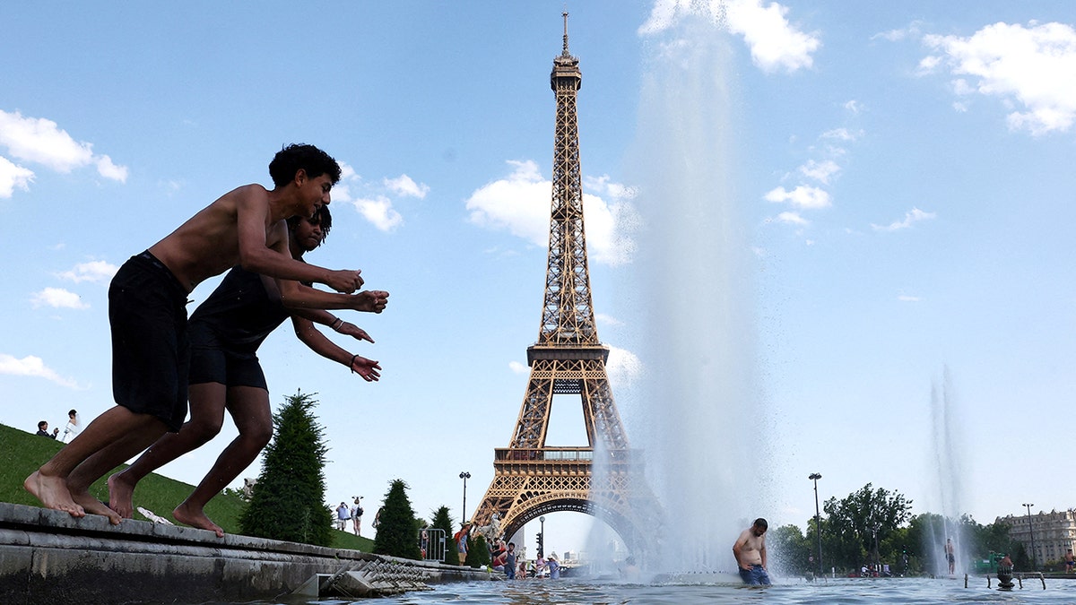Kids jumping into the fountain at the Eiffel Tower.