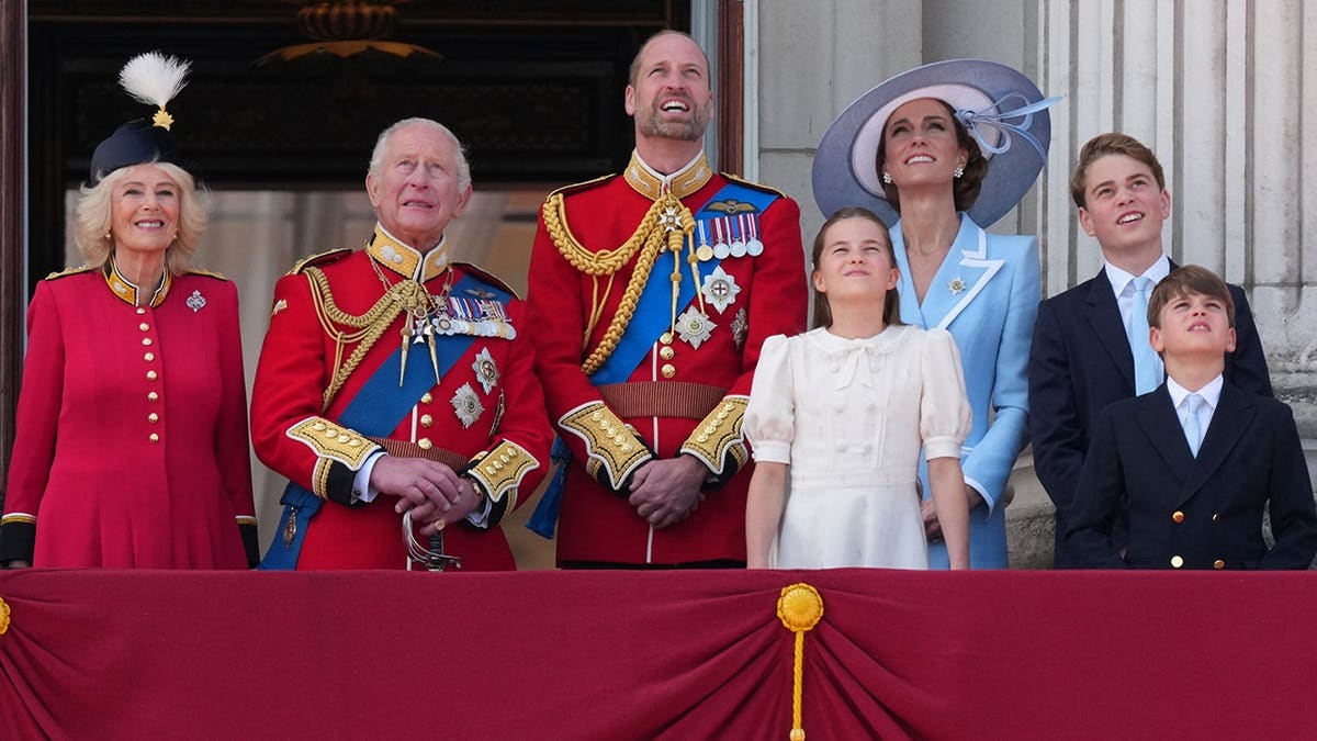 King Charles III and Queen Camilla watching a fly past from Buckingham Palace balcony with royal family