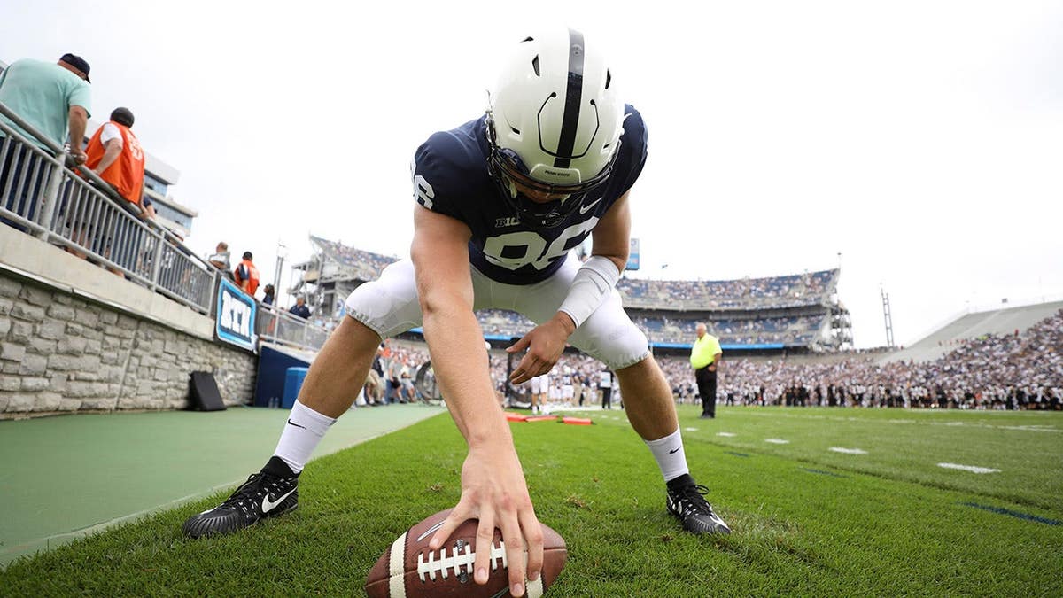 Penn State player Kyle Vasey warming up on sidelines at Beaver Stadium