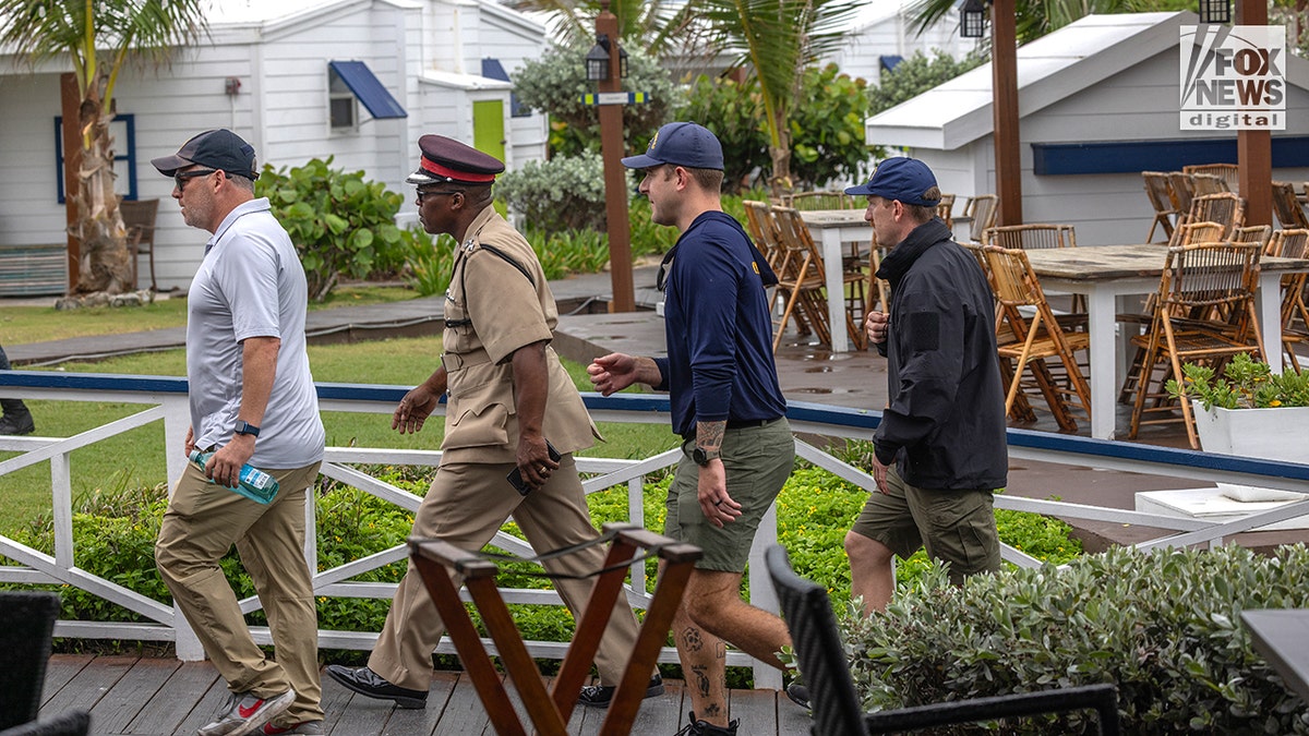 Members of the US Coast Guard and Bahamian Defence Force arriving at The Abaco Inn in Hope Town