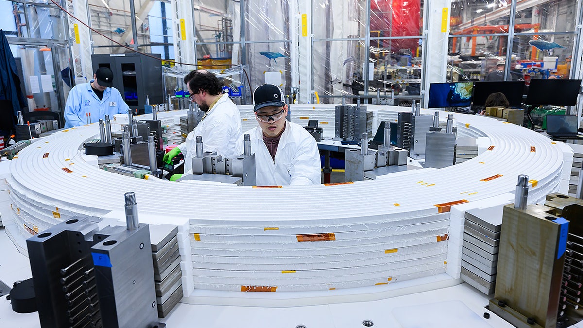 Engineers work inside a Commonwealth Fusion Systems facility.