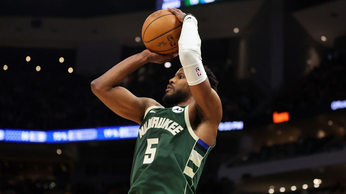 Malik Beasley of the Milwaukee Bucks shooting a three-point shot during a basketball game