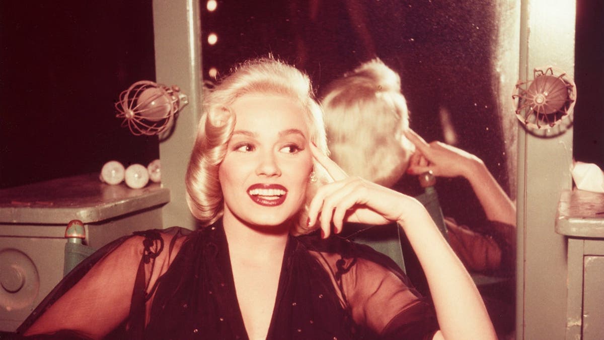 Mamie Van Doren posing for a photo