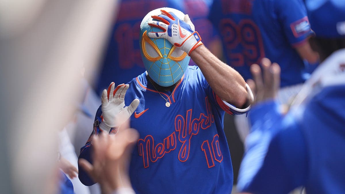 New York Mets' Marcus Semien celebrating in the dugout during a baseball game.