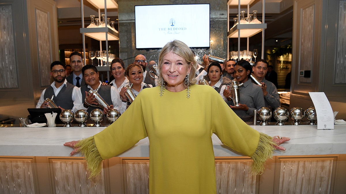 Martha Stewart poses in front of the bar and bartenders at The Bedford in Las Vegas.