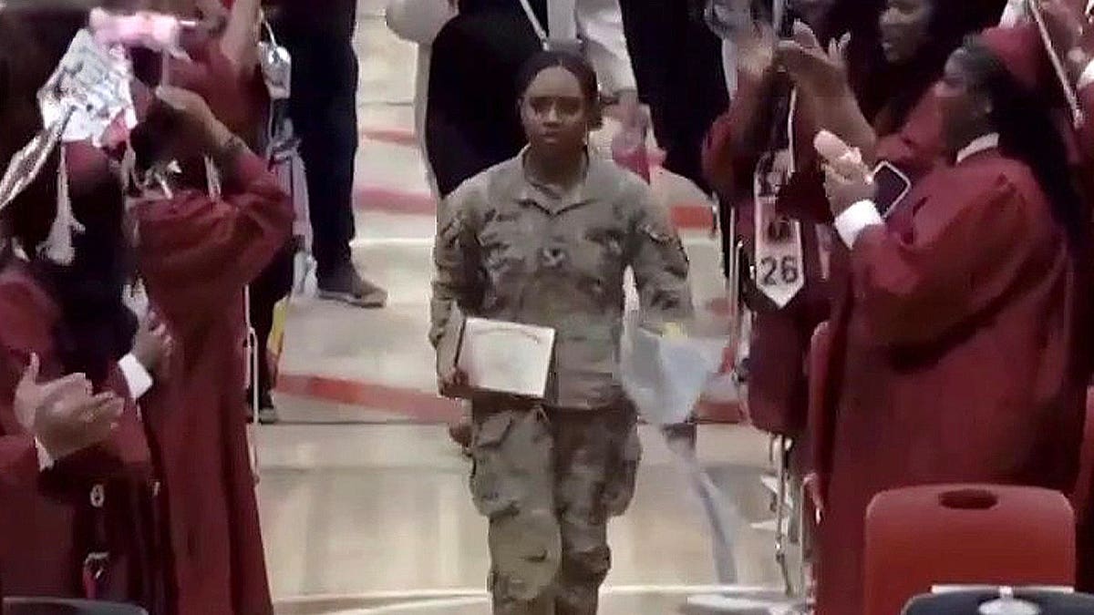Mauriana Barksdale holding diploma