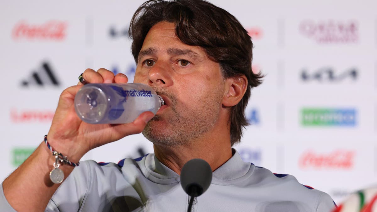 Mauricio Pochettino drinking water during a press conference in Los Angeles