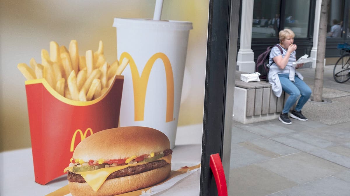 A sign showing a McDonald's meal with French fries, a burger and a drink.