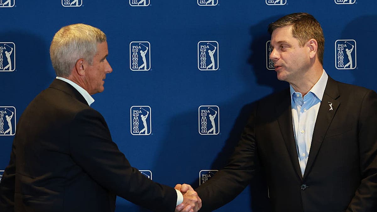 Jay Monahan (commissioner of the PGA TOUR) shakes hands with Brian Rolapp as it is announced Rolapp will become the next commissioner