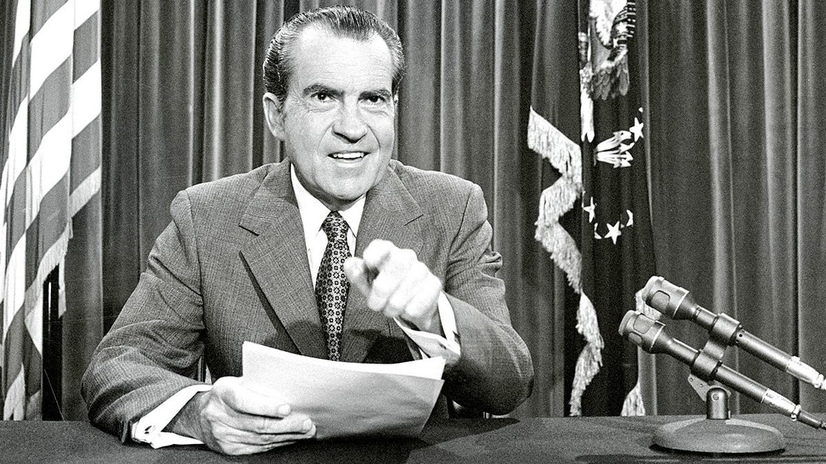 Richard Nixon poses in White House office as president.