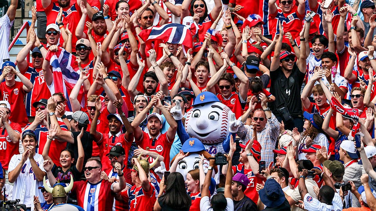 Norway national soccer team fans with Mr. and Mrs. Met at Citi Field during a baseball game.