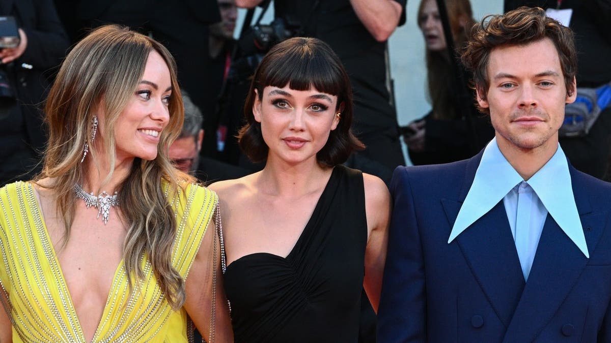 Olivia Wilde, Sydney Chandler and Harry Styles posing on the red carpet at the Venice International Film Festival.