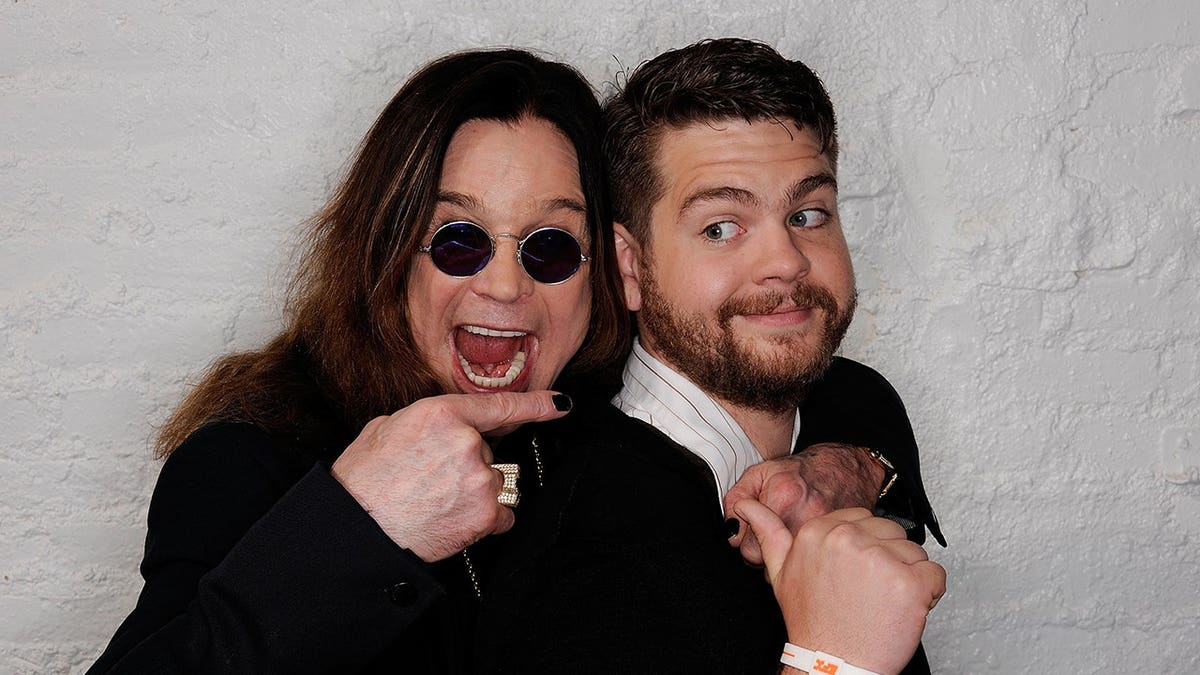 Ozzy Osbourne and son Jack Osbourne standing together at the Tribeca Film Festival portrait studio.
