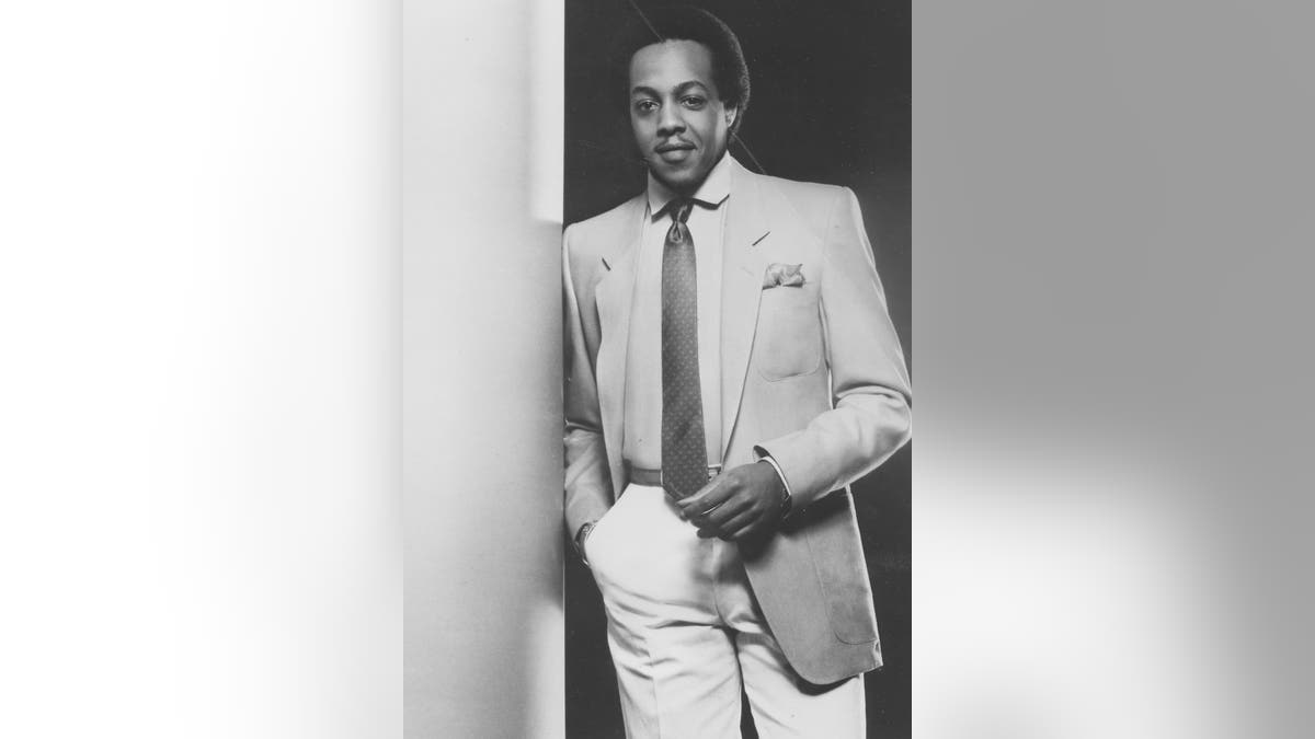 Peabo Bryson standing and smiling as a young man in 1975