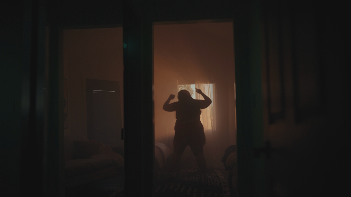 A silhouetted woman stands inside the Pearadise house featured in the documentary