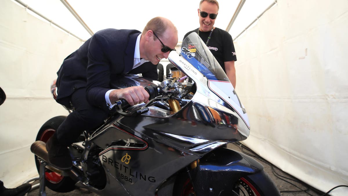 Prince William, Duke of Cambridge, trying out a motorbike at the Isle of Man TT event