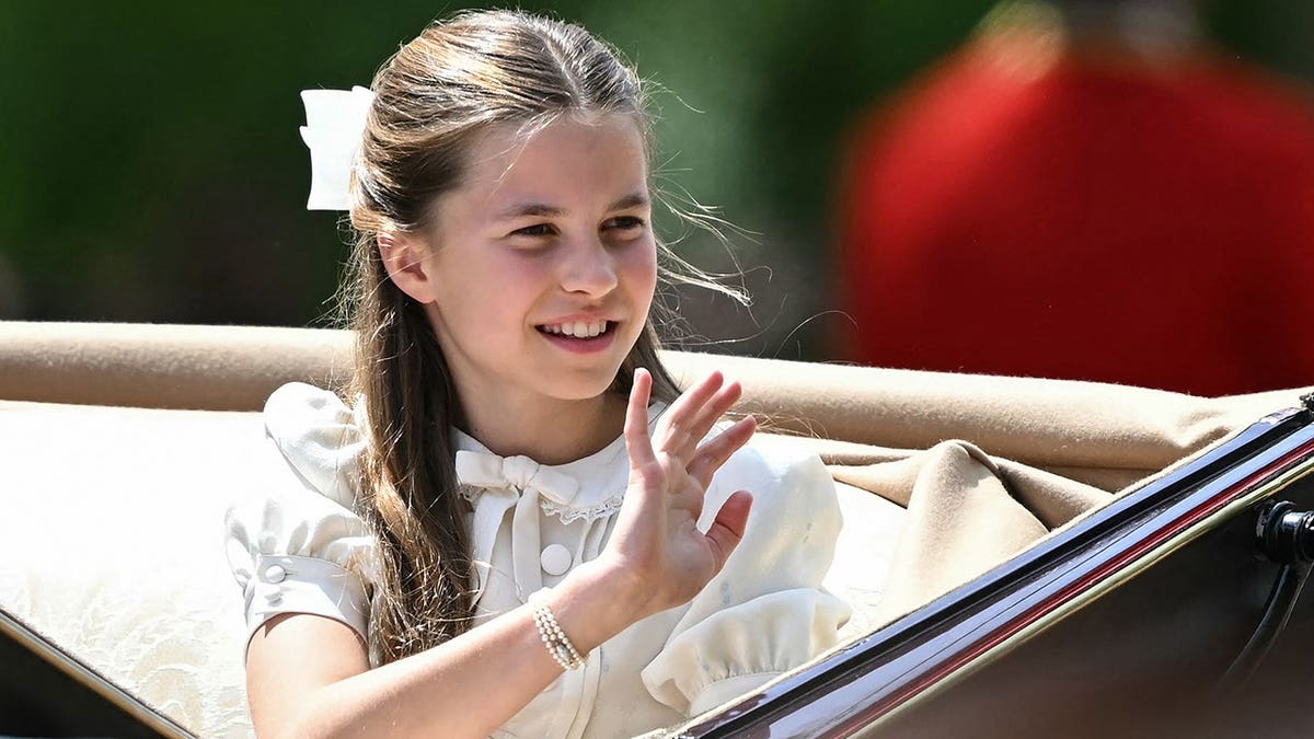 Princess Charlotte of Wales waving while walking near Buckingham Palace in London